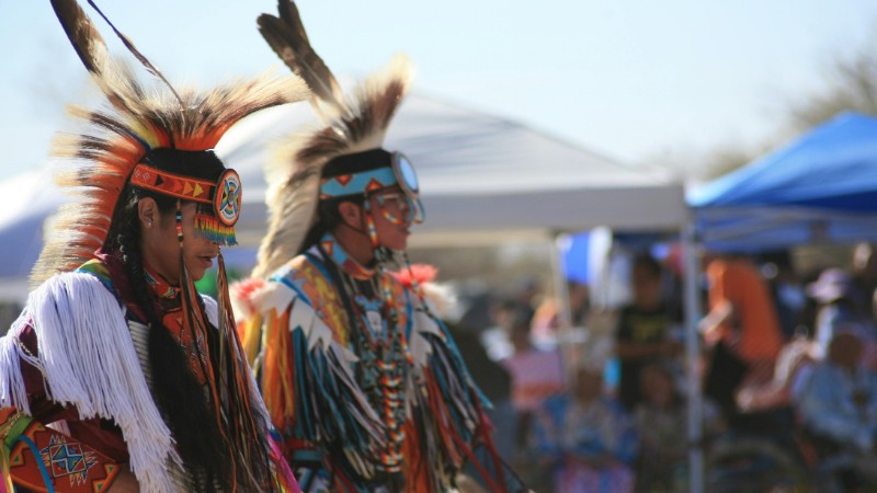 Two Native American dancers in vibrant regalia performing a traditional dance outdoors., tags: van de wet op media voor inheemse - pexel